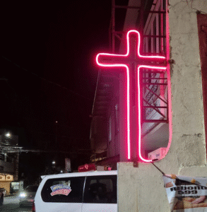 Cross in neon lights Windows Doors and Gates
